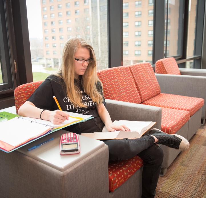 Resident studying in Bishop Hall lounge